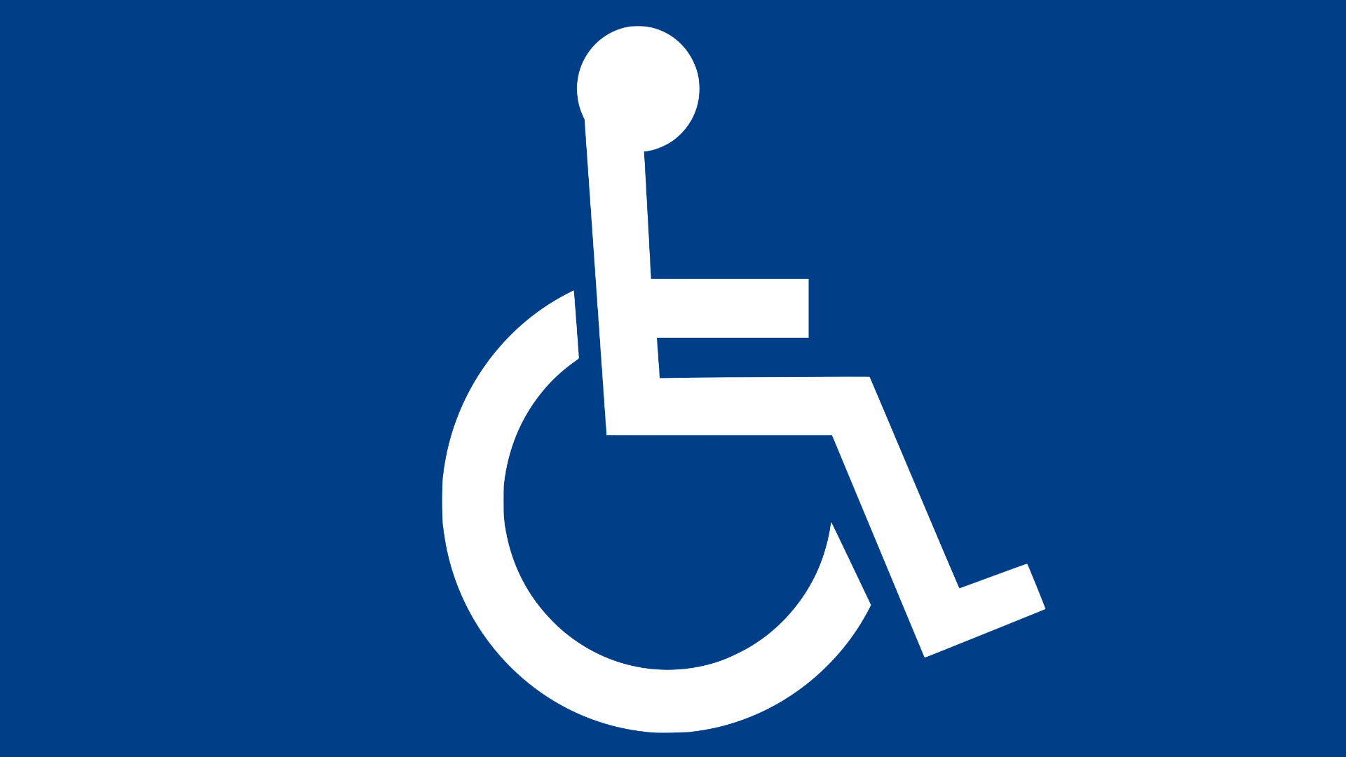Biała sylwetka osoby na wózku inwalidzkim na ciemnoniebieskim tle, która jest symbolem niepełnosprawności